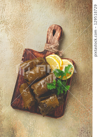 dolma, minced meat with rice, in grape leaves, minced meat rolls, on a chopping board, top view, no people, dolma, minced meat with rice, in grape leaves, minced meat rolls, on a chopping board, top view, no people, 129518729