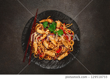udon noodles, with squid and vegetables, on a black plate, homemade, no people, udon noodles, with squid and vegetables, on a black plate, homemade, no people, 129518733