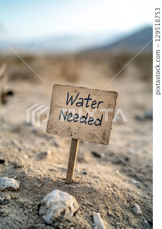 There is an urgent need for water in the dry and parched landscape, as highlighted by this sign about water scarcity There is an urgent need for water in the dry and parched landscape, as highlighted by this sign about water scarcity 129518753
