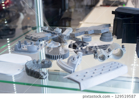 Objects printed on 3D printer from molten plastic powder. Different models printed on 3D printer from melted grey polyamide powder. Multi Jet Fusion MJF technology. New additive 3D printing technology 129519587