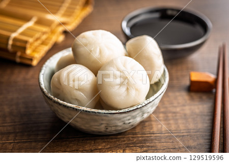Xiao long bao. Chinese dumplings in bowl on wooden table. 129519596