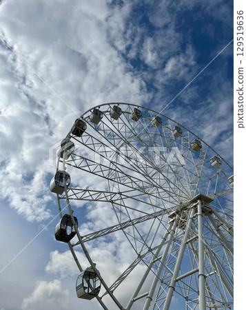 Ferris wheel on the background of blue sky in summer. High quality photo Ferris wheel on the background of blue sky in summer. High quality photo 129519636