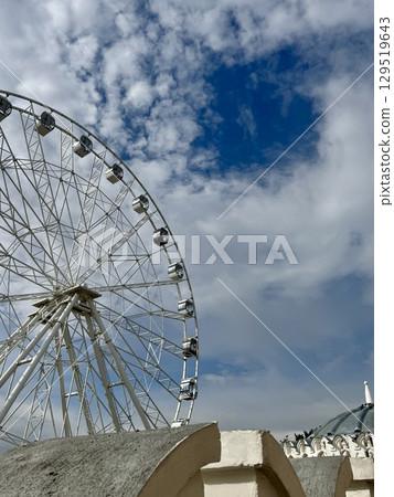 Ferris wheel on the background of blue sky in summer. High quality photo Ferris wheel on the background of blue sky in summer. High quality photo 129519643