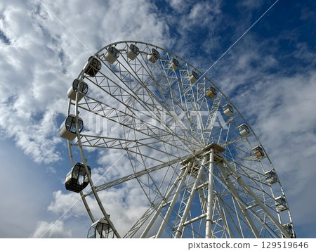 Ferris wheel on the background of blue sky in summer. High quality photo Ferris wheel on the background of blue sky in summer. High quality photo 129519646