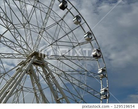 Ferris wheel on the background of blue sky in summer. High quality photo 129519654