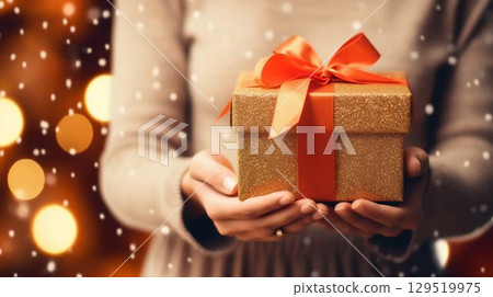 Festive Offering: Woman's Hands Holding Giftbox with Ribbon, Christmas Background. Generative ai Festive Offering: Woman's Hands Holding Giftbox with Ribbon, Christmas Background. Generative ai 129519975