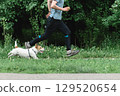 Athletic man jogging with Jack Russell Terrier dog in park - active pet owner lifestyle 129520654