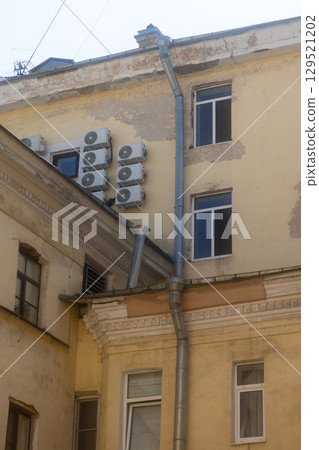 Air conditioners are installed on facade of building. device for comfortable living in hot weather. Air conditioners are installed on facade of building. device for comfortable living in hot weather. 129521202