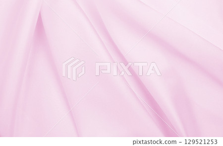 Smooth elegant pink silk or satin texture as wedding background. Luxurious background design 129521253