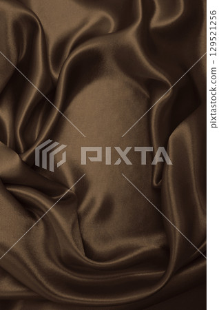 Smooth elegant brown silk or satin luxury cloth texture as abstract background. Luxurious background design wallpaper. In Sepia toned. Retro style 129521256