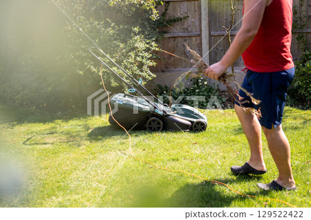 Lawn mowing in the garden, cutting green grass in the summer 129522422