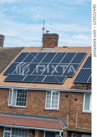 Solar panels on a house roof. Modern house and solar energy. 129522440