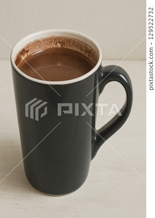 Black ceramic mug filled with hot black coffee 129522732