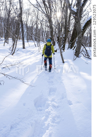 Image of enjoying fresh snow in the forest on snowshoes Oyamakiyazawa mountain stream 129523075