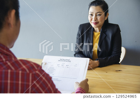 Job HR applicants having an interview with Human resource manager jobs interviewing with confident candidate at business firm office give cv resume. Job Interview with headhunter agent and applicant Job HR applicants having an interview with Human resource manager jobs interviewing with confident candidate at business firm office give cv resume. Job Interview with headhunter agent and applicant 129524965
