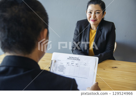 Job HR applicants having an interview with Human resource manager jobs interviewing with confident candidate at business firm office give cv resume. Job Interview with headhunter agent and applicant 129524966