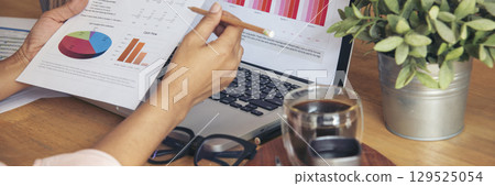 Banner woman working office desk reading financial report finance chart graph on table. Wide tax audit woman hands working paperwork office. Banner Businesswoman Audit financial with copy space 129525054