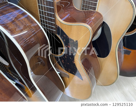 Various acoustic guitars lined up Various acoustic guitars lined up 129525110