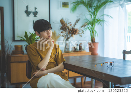 Lifestyle of a man sitting in a chair and relaxing Lifestyle of a man sitting in a chair and relaxing 129525223