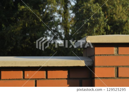 View of brick foundation. Brick wall with white finish. Brick base. Brick background with pillar. Building and construction concept. 129525295