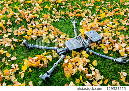 Happy humanoid robot lies on the autumn grass. Happy humanoid robot lies on the autumn grass. 129525353