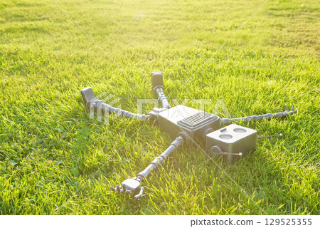 Happy humanoid robot lies on the autumn grass. Happy humanoid robot lies on the autumn grass. 129525355