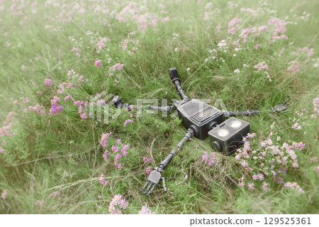 Happy humanoid robot lies on a meadow among wildflowers. Robotic object experiences feelings and emotions. Concept of technology development in the form of artificial intelligence. Happy humanoid robot lies on a meadow among wildflowers. Robotic object experiences feelings and emotions. Concept of technology development in the form of artificial intelligence. 129525361