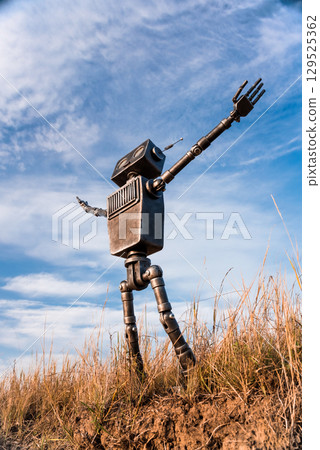 Robot on a background of blue sky Robot on a background of blue sky 129525362