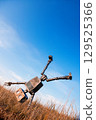 Robot on a background of blue sky 129525366