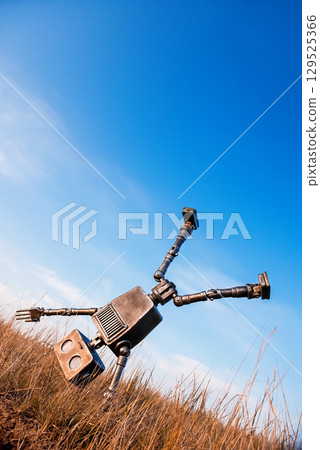 Robot on a background of blue sky Robot on a background of blue sky 129525366