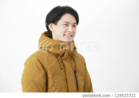 Man wearing down jacket, portrait, white background Man wearing down jacket, portrait, white background 129525722