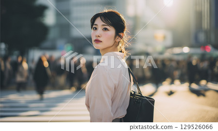 A woman waiting at a traffic light on her morning commute 129526066