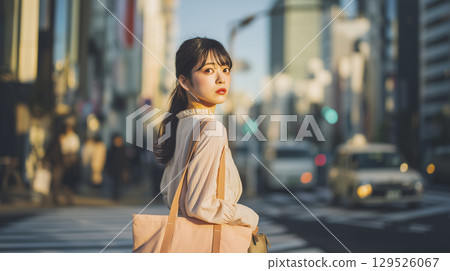 A woman waiting at a traffic light on her morning commute 129526067