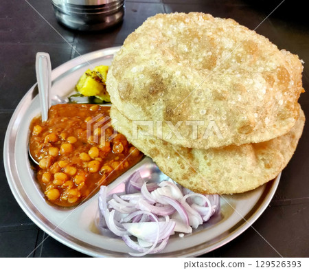 Chole bhature is a North Indian famous food dish. Chole bhature is a North Indian famous food dish. 129526393