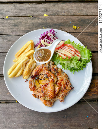 Grilled Chicken Steak with French Fries and Fresh Salad on White Plate Grilled Chicken Steak with French Fries and Fresh Salad on White Plate 129527544