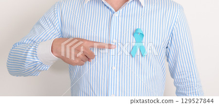 man with blue Ribbon for concept of blue November, November Prostate Cancer Awareness month, World Diabetes day , Men Health month, International men, Father day. Healthcare and world cancer day man with blue Ribbon for concept of blue November, November Prostate Cancer Awareness month, World Diabetes day , Men Health month, International men, Father day. Healthcare and world cancer day 129527844