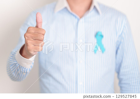 man with blue Ribbon for concept of blue November, November Prostate Cancer Awareness month, World Diabetes day , Men Health month, International men, Father day. Healthcare and world cancer day 129527845