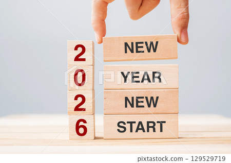 hand holding wooden block with text 2026 NEW YEAR NEW START on table background. Resolution, strategy, solution, business and holiday concepts hand holding wooden block with text 2026 NEW YEAR NEW START on table background. Resolution, strategy, solution, business and holiday concepts 129529719