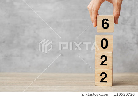 hand holding block 2026 text on table. Resolution, strategy, plan, goal, motivation, reboot, business and New Year holiday concepts hand holding block 2026 text on table. Resolution, strategy, plan, goal, motivation, reboot, business and New Year holiday concepts 129529726