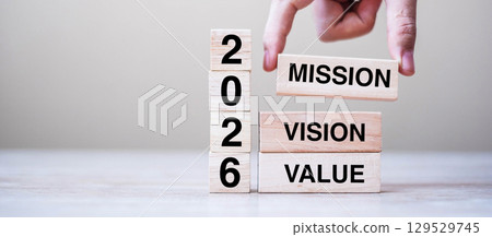 wooden block with text 2026 MISSION, VISION and VALUE on table background. Resolution, strategy, solution, goal, business and New Year holiday concepts 129529745