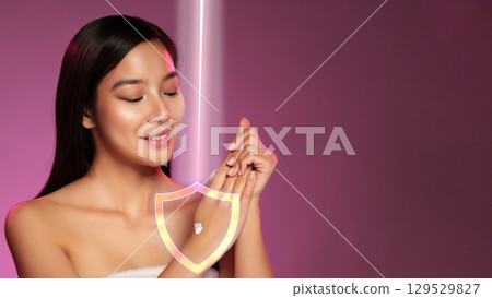 Woman applying skincare product on her hand in a modern wellness studio during a bright afternoon Woman applying skincare product on her hand in a modern wellness studio during a bright afternoon 129529827