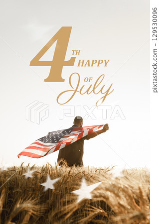 Celebrating Independence Day with an American flag against a sunset backdrop in a golden wheat field 129530096
