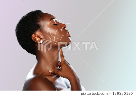 Woman showcasing skincare techniques for facial rejuvenation in a serene studio setting during daylight 129530150