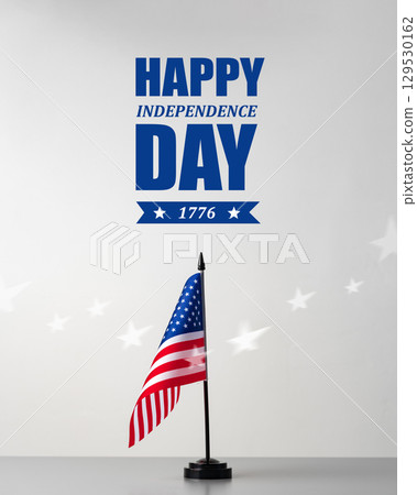 Celebrating Independence Day with an American flag displayed against a simple backdrop 129530162