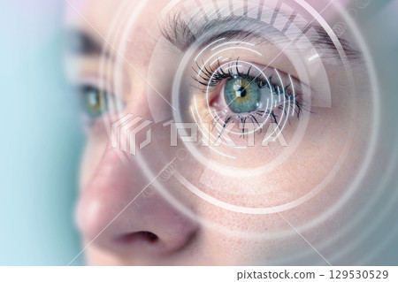 Close-up view of a person's eye with digital overlay indicating technology and vision enhancement concepts Close-up view of a person's eye with digital overlay indicating technology and vision enhancement concepts 129530529