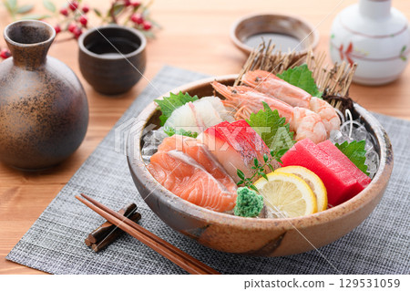A luxurious sashimi platter with plenty of fresh seafood and sake. High-quality food photos perfect for banquets and menus. A luxurious sashimi platter with plenty of fresh seafood and sake. High-quality food photos perfect for banquets and menus. 129531059