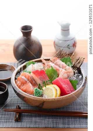 A luxurious sashimi platter with plenty of fresh seafood and sake. High-quality food photos perfect for banquets and menus. 129531071