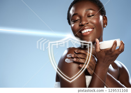 Skincare routine featuring a smiling woman applying lotion with radiant blue background Skincare routine featuring a smiling woman applying lotion with radiant blue background 129531108