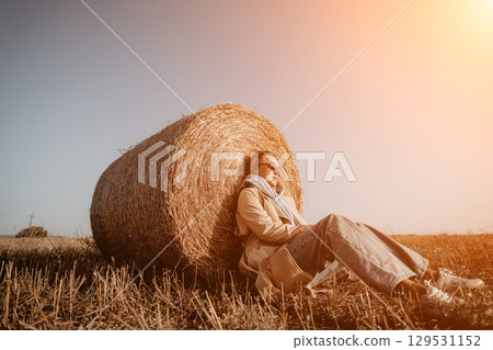Woman Relaxing by a Hay Bale 129531152