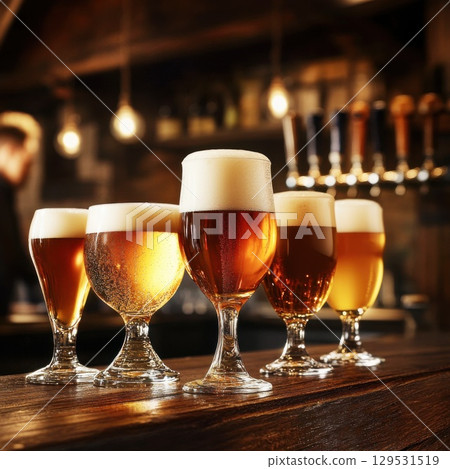 glasses of fresh cold light beer on a wooden bar counter in pub glasses of fresh cold light beer on a wooden bar counter in pub 129531519
